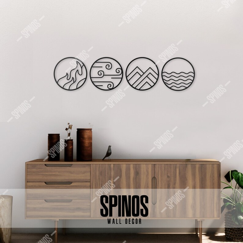 May include: Four black metal circles with different designs representing the four elements: fire, air, earth, and water. The circles are mounted on a white wall above a wooden dresser with the text "SPINOS WALL DECOR" on the front.