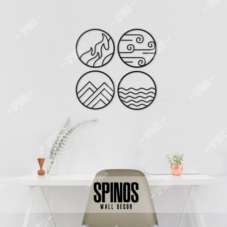 May include: Four black metal wall decor circles with different designs representing the four elements: fire, air, earth, and water. The circles are arranged in a square pattern on a white wall. The text "SPINOS WALL DECOR" is visible at the bottom of the image.
