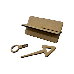 May include: A wooden craft kit with three pieces: a rectangular base with a shelf, a small key with a ring, and a triangular arrow.