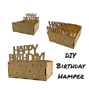 May include: Three wooden DIY birthday hamper boxes. Each box is a light brown color and features the words "Happy Birthday" cut out on the front. The boxes have balloon and star cutouts. The text "DIY Birthday Hamper" is also visible.