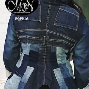 May include: A blue denim jacket with a patchwork design on the back. The jacket has a fitted waist and a pointed hem. The label on the jacket reads "du Mon couture avec amour" and "SOPHIA".