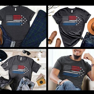 Puede incluir: Una camiseta gris oscuro jaspeada con un dise&ntilde;o de bandera estadounidense desgastado que presenta una l&iacute;nea azul fina y siluetas blancas de aviones. La camiseta se muestra en un modelo que lleva pantalones vaqueros azules y un reloj.