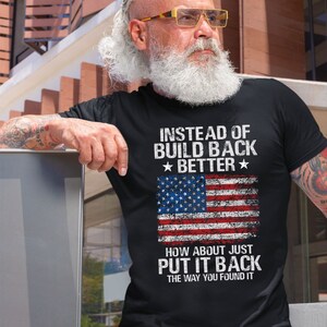 This is a picture of a man wearing a USA flag shirt. The picture is of a distressed American flag, a distressed USA flag.