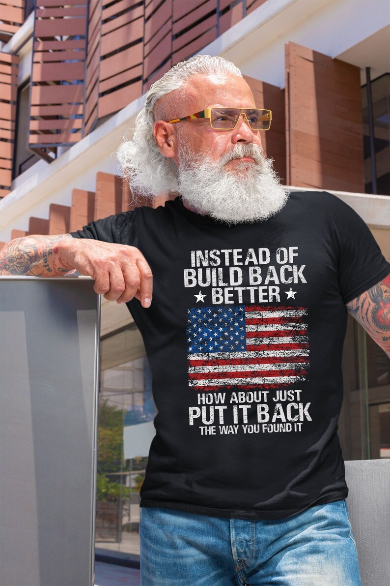 This is a picture of a man wearing a USA flag shirt. The picture is of a distressed American flag, a distressed USA flag.