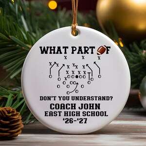 Personalized football coach ceramic Christmas ornament displayed in gift box with golden hanging string, custom coach name, school and season, football playbook design, team coach thank you gift, holiday keepsake and end of season gift, Mom’s Next Adventure.