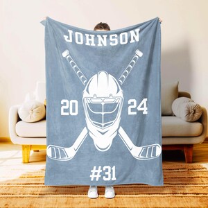 Personalized hockey player blanket in indigo with name and number – Moms Next Adventure