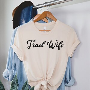 This is a picture of a traditional wife wearing a trad wife t shirt.