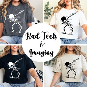 May include: Four t-shirts in different colors: charcoal, white, black, and beige. Each shirt features a white skeleton graphic in a dabbing pose with anatomical labels. The text "Rad Tech & Imaging" is in a circular design.