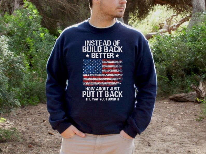 This is a picture of a man wearing a USA flag shirt. The picture is of a distressed American flag, a distressed USA flag.