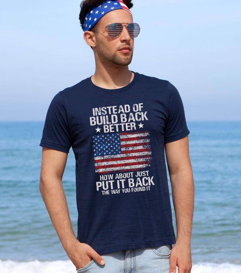 This is a picture of a man wearing a USA flag shirt. The picture is of a distressed American flag, a distressed USA flag.