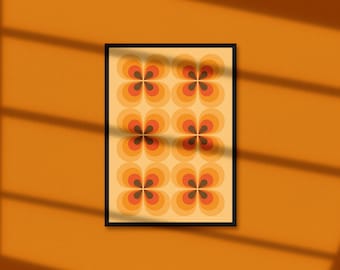 May include: A framed print with a retro pattern of orange, brown, and yellow flowers. The print is on a light yellow background.