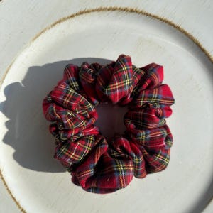 May include: Red and yellow plaid scrunchie hair tie.