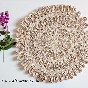 May include: A natural fiber round placemat with a woven design. The placemat is 16 inches in diameter and has a light beige color.