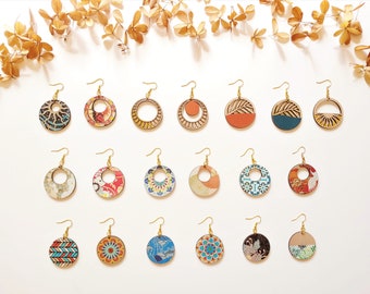 May include: A collection of 20 unique wooden earrings with various patterns and designs. The earrings are circular and feature a variety of colors, including blue, red, green, and yellow. The earrings are arranged in three rows on a white background.