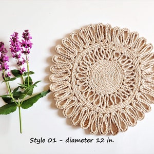 May include: A round, natural fiber placemat with a woven design. The placemat is 12 inches in diameter and has a light brown color.