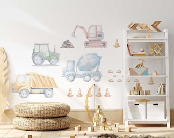 May include: Watercolor wall decals of construction vehicles, including a dump truck, cement mixer, excavator, and tractor. The decals are in soft pastel colors and are arranged on a white wall. Orange traffic cones and small rock piles are also included.