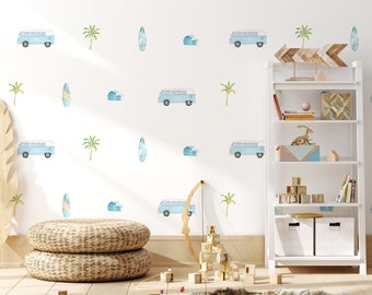 May include: A white wall decorated with watercolor illustrations of light blue vans, surfboards, palm trees, and waves. The room features a white bookshelf, woven floor cushions, and wooden blocks, creating a beach-themed nursery or playroom.