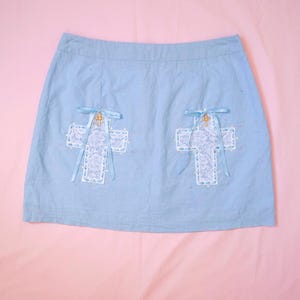 Pastel Blue Mini Skirt with Two Lace Crosses, Woven Ribbon Bows, Cross Charms and Sparkly Rhinestones - Kawaii Upcycled Fashion