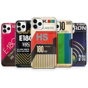 May include: Five smartphone cases featuring designs inspired by vintage VHS video cassette labels. The cases display various color schemes including pink, black, beige, and blue, with printed text such as E-180, HS, and 4 Hrs E-240, alongside VHS logos.