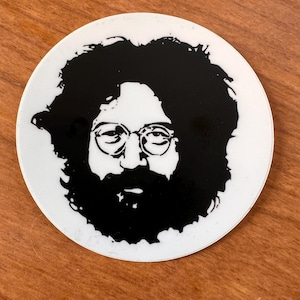May include: Black and white silhouette sticker of a man with long hair and a beard wearing glasses.