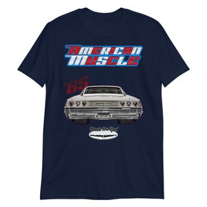 May include: Navy blue t-shirt with a red, white, and blue "American Muscle" graphic. The graphic also includes a silver 1965 Chevrolet Impala with red "Uncle Hot Rod" text.
