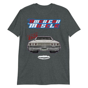 May include: A grey t-shirt with a red, white, and blue "American Muscle" graphic. The graphic also includes a silver 1965 Chevrolet Impala with the text "Woola Hot Rod" underneath.