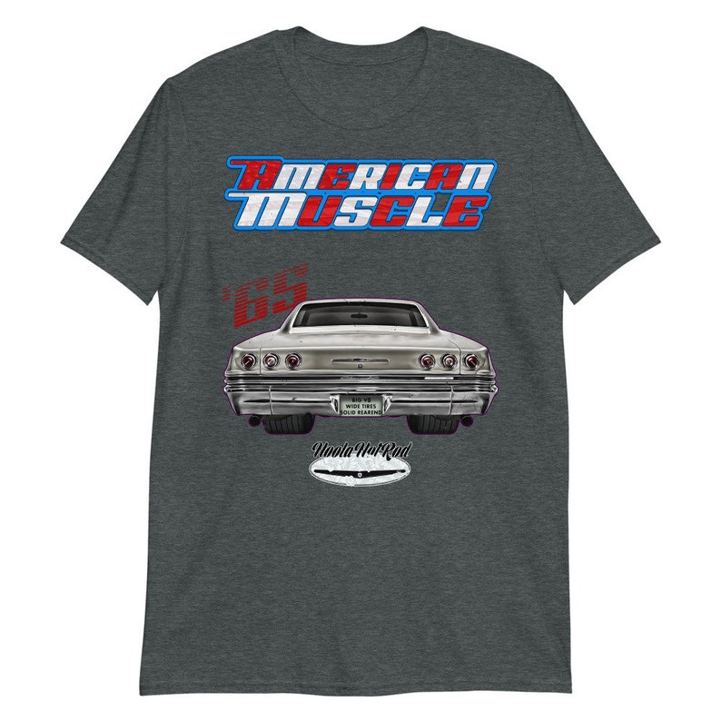 May include: A grey t-shirt with a red, white, and blue "American Muscle" graphic. The graphic also includes a silver 1965 Chevrolet Impala with the text "Woola Hot Rod" underneath.