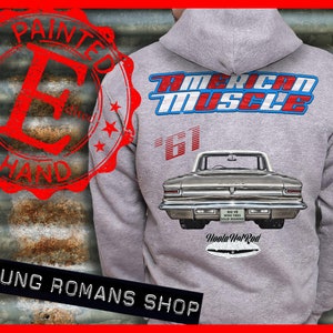 May include: A grey hooded sweatshirt with a vintage car design on the back. The car is a 1961 Oldsmobile Cutlass with the text "American Muscle" and "Woola Hot Rod" printed on the back. The sweatshirt has a red stamp on the front that says "Painted by Hand".