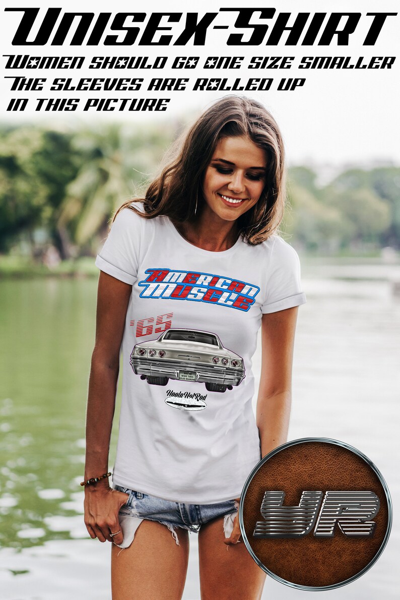 May include: White unisex t-shirt with a vintage car graphic and the text "American Muscle" and "65" printed on the front. The car is a silver 1965 Chevrolet Impala. The sleeves are rolled up. The text "Hoola Hot Rod" is printed below the car graphic.