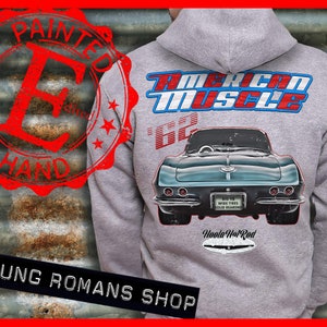 May include: A gray hoodie featuring a teal classic car graphic on the back, with the words "American Muscle" in red and blue. The hoodie also has the text "Painted by Hand" and "Young Romans Shop".