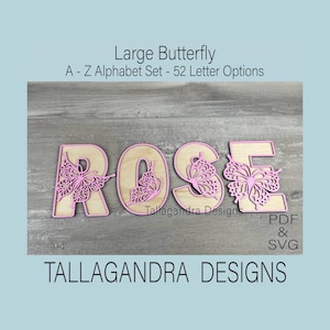 May include: A set of wooden letters spelling "ROSE" with pink butterfly cutouts. The letters are on a wood background. The letters are part of a larger alphabet set with 52 letter options. The image includes the text "Large Butterfly A - Z Alphabet Set - 52 Letter Options" and "Tallagandra Designs PDF & SVG TALLAGANDRA DESIGNS".