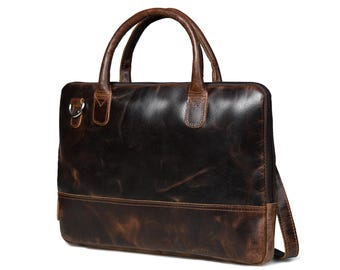 May include: A brown leather briefcase with a top handle and a shoulder strap. The bag has a distressed look and a flap closure.