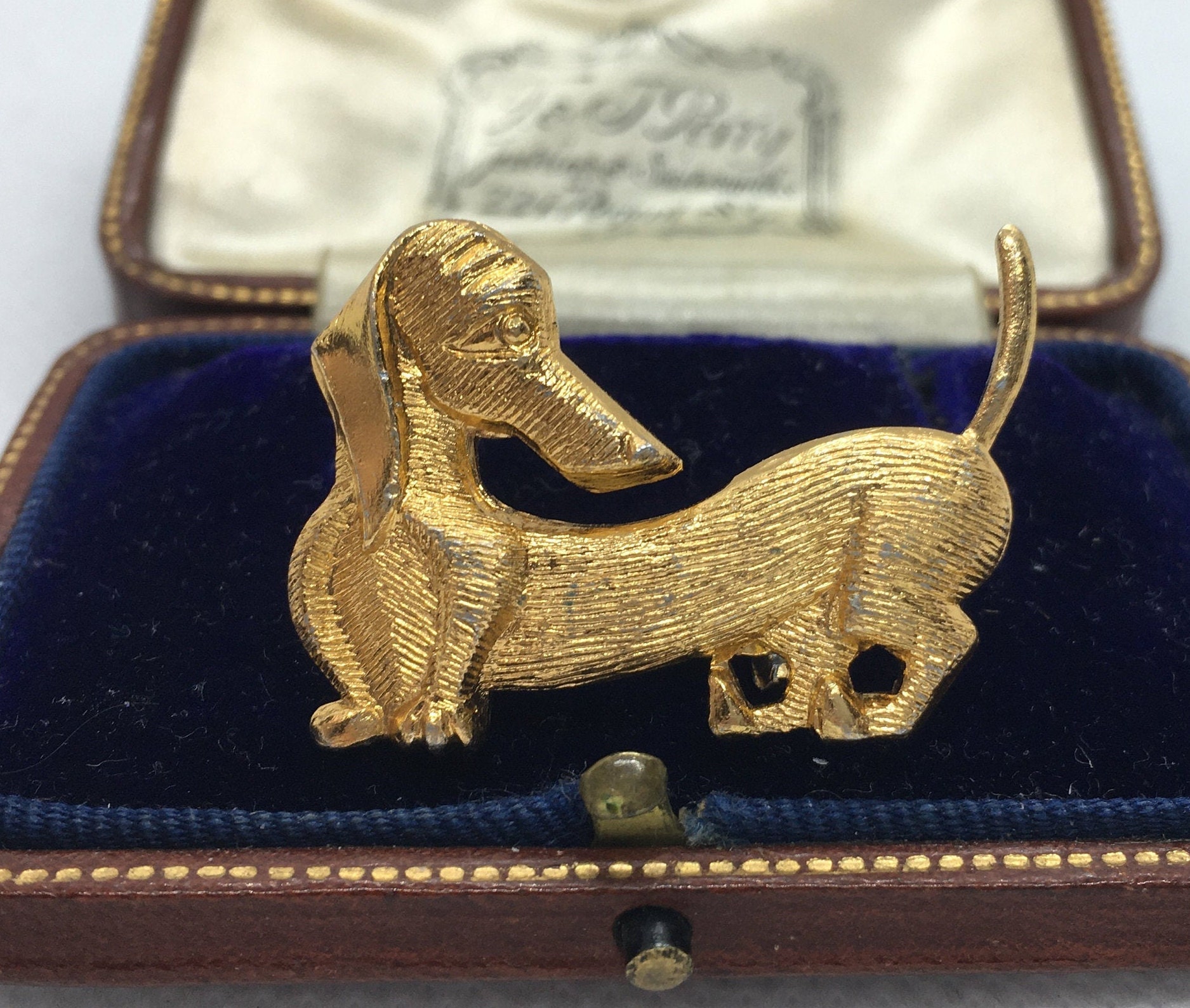 Dachshund dog pin, pewter look, pink eyes, very nice finish.