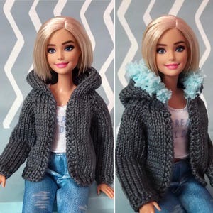 May include: A doll with blonde hair wearing a gray knit hooded jacket over a white tank top and blue jeans. The jacket has a textured appearance. The doll is smiling. The tank top has the letters "REA LD" printed on it.