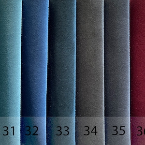 May include: A fabric swatch card displaying ten different colours, ranging from light green to brown. The card is labelled "ROK E-18" and the colours are numbered 29 through 38.