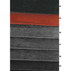 May include: Close-up of a layered fabric with a dark green, red, and gray color scheme. The fabric has a textured surface and appears to be woven.