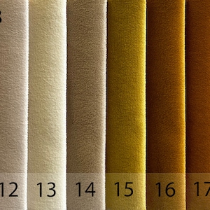 May include: A fabric swatch card displaying 10 different fabric samples. The samples range in colour from light brown to dark red. The card is labelled "ROK E-18" and "ROK".