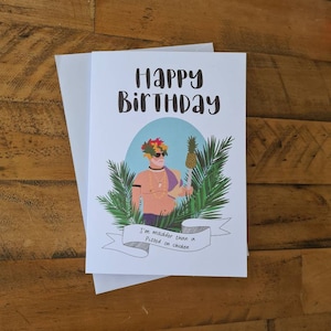 May include: A birthday card featuring a cartoon illustration of a person wearing a pineapple on their head and sunglasses. The text on the card reads "Happy Birthday" and "I'm madder than a pissed off chicken".