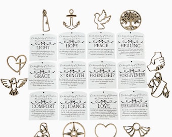 May include: A collection of gold-colored Christmas ornaments in various shapes, including a candle, anchor, dove, tree, heart, and angel. Each ornament is paired with a tag featuring a word like "Light" or "Hope" and a related Bible verse.
