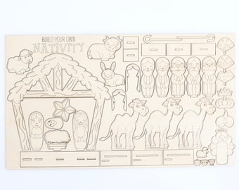 Könnte beinhalten: Ein Holz-Bastelset zum Bau einer Weihnachtskrippe. Das Set enthält einen Stall, eine Krippe, einen Stern, einen Esel, ein Kamel, ein Schaf, eine Kuh, drei Könige, Maria, Josef und das Jesuskind. Das Set ist mit "Bauen Sie Ihre eigene Krippe" beschriftet.