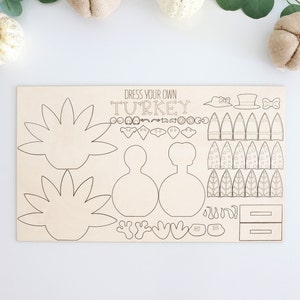 May include: A wooden craft kit for kids to dress up their own turkey. The kit includes a turkey body, feathers, a hat, a bow tie, and other accessories. The kit is perfect for a Thanksgiving craft activity.