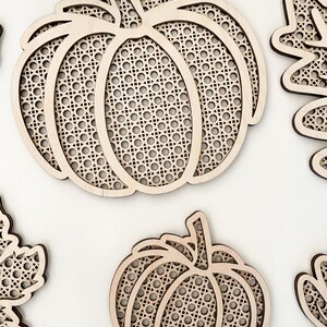 May include: Two wooden pumpkin shapes with a lattice design. The pumpkins are unfinished and ready to be painted or stained.