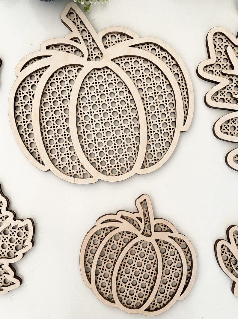 May include: Two wooden pumpkin shapes with a lattice design. The pumpkins are unfinished and ready to be painted or stained.