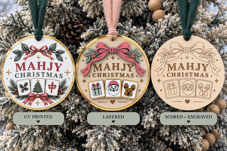 May include: Three round ornaments labeled UV PRINTED, LAYERED, and SCORED + ENGRAVED. Each features the text MAHJY CHRISTMAS, a bow, and three mahjong tiles. The first is printed, the second has layered elements, and the third is laser engraved.
