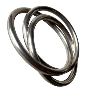 May include: A silver-colored, intertwined ring composed of three interlocking circular bands. The bands have a smooth, reflective surface, creating highlights and shadows. The design is simple and modern, suitable for jewelry or decorative purposes.