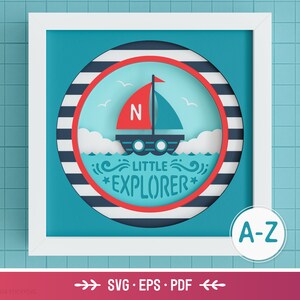 May include: A blue and red paper craft design with a sailboat, clouds, and waves. The design is in a white frame with a blue background. The text "Little Explorer" is written in red and white. The text "A-Z" is written in blue and white. The text "SVG - EPS - PDF" is written in black and white.