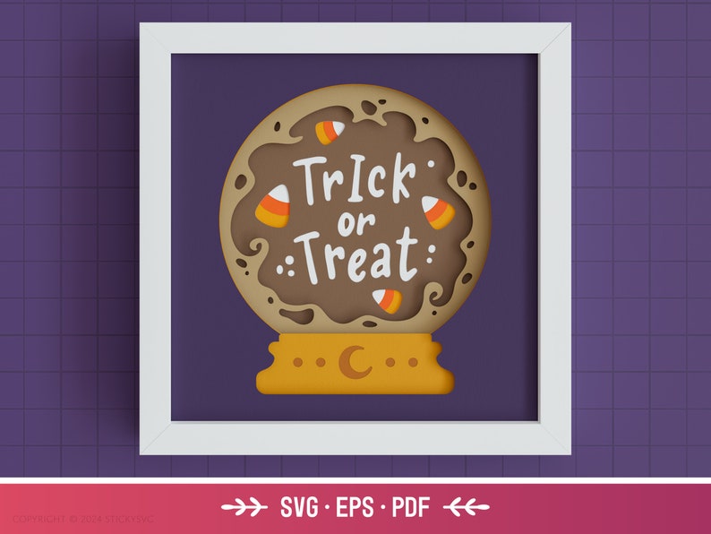 May include: A brown papercraft Halloween-themed snow globe with the text "Trick or Treat" and candy corn decorations. The snow globe is on a yellow base with a crescent moon.