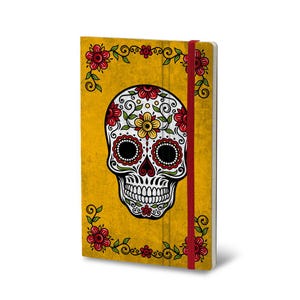 May include: A rectangular notebook with a mustard yellow cover featuring a central white sugar skull illustration decorated with red, yellow, and green floral patterns. A red elastic band secures the notebook, which is framed by red flowers.