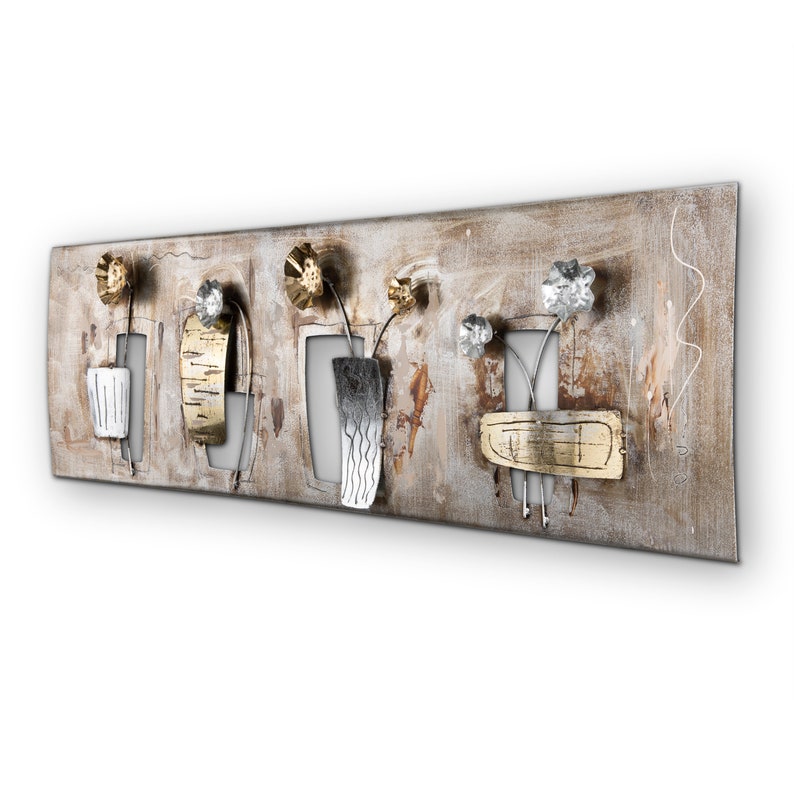 May include: A metal wall art piece with a rustic brown background and five stylized flowers in gold and silver. The flowers are arranged in a row and are attached to the wall with a metal backing.
