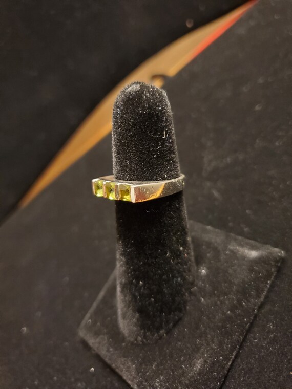 Silver ring with bright green stones